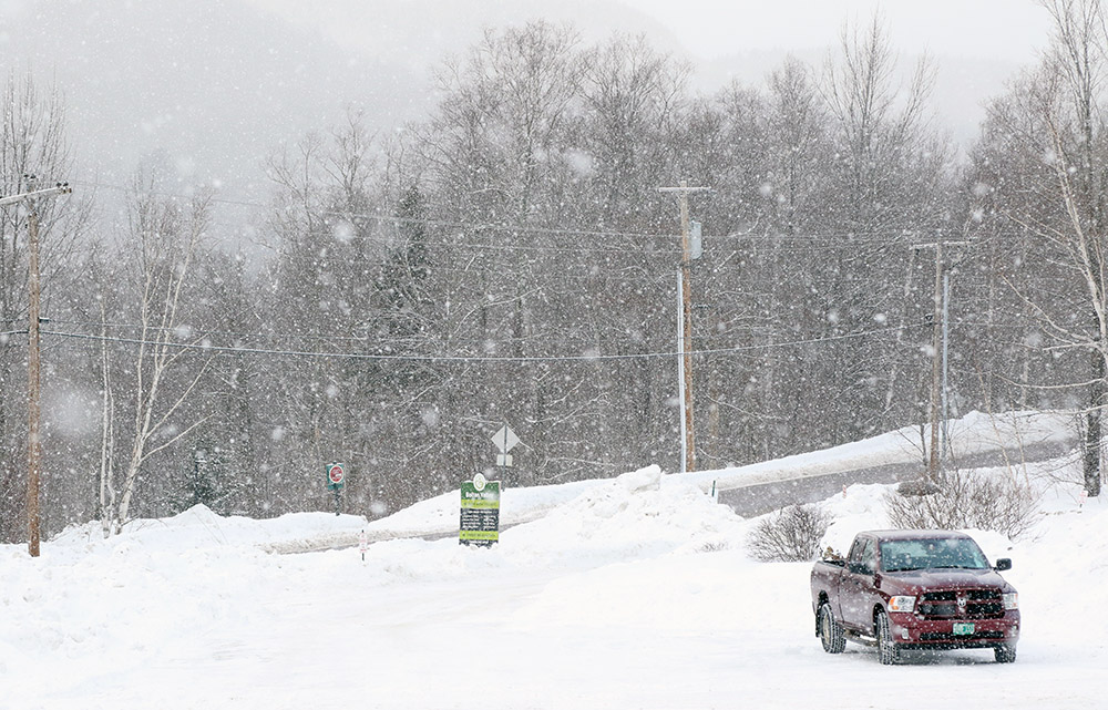 An image of big flakes of snwo falling at the Timberline base area at Bolton Valley Resort in Vermont
