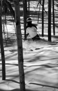 An image of Dylan skiing powder snow in the Snow Hole area at Bolton Valley Resort in Vermont