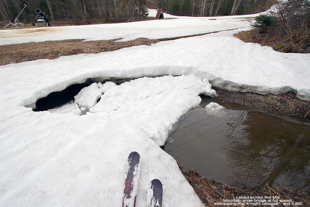 An image showing a collapsed snow bridge in May in the mid mountain area of Bolton Valley Ski Resort in Vermont