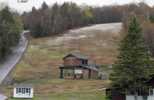 An image showing a dusting of May snow at an elevation of 1,300 feet near the base of the Toll House chairlift at Stowe Mountain Resort in Vermont