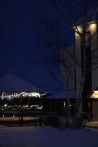An image of holiday lights in the evening in the center of the Village at Bolton Valley Ski Resort in Vermont