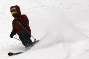 An image of Dylan Telemark skiing in powder after Winter Storm Gage at Bolton Valley Resort in Vermont