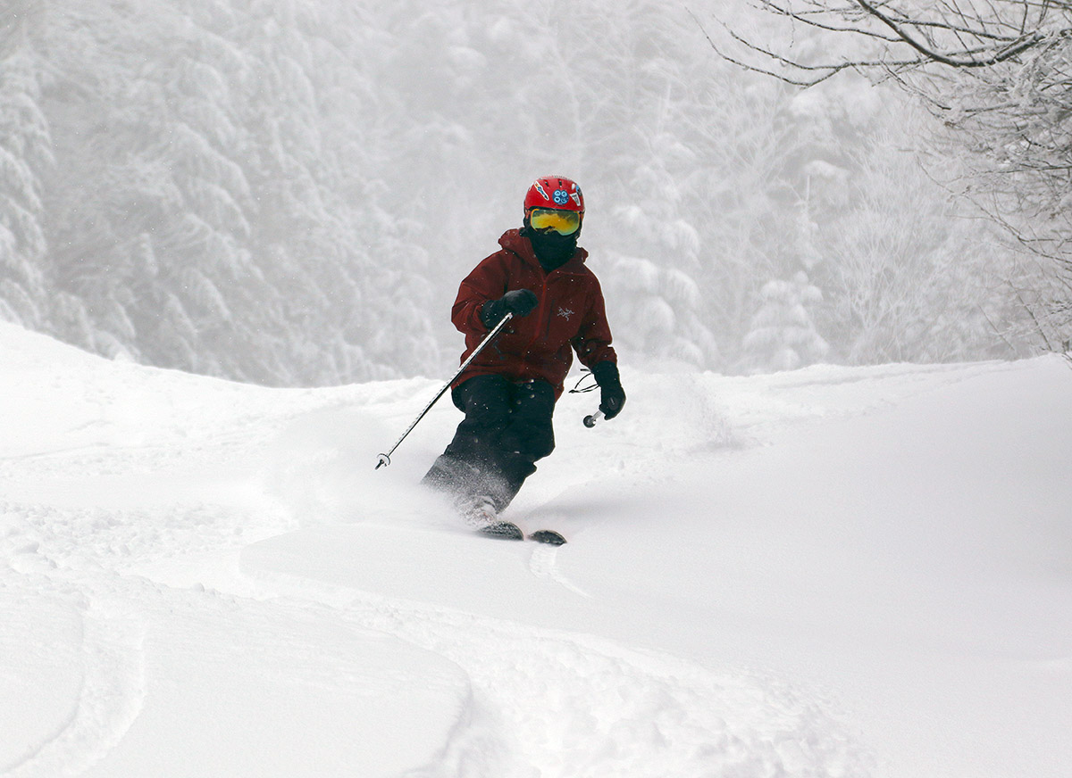An image of Dylan skiing powder during Winter Storm Jacob in the Cobrass area at Bolton Valley Resort in Vermont
