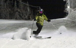 An image of Erica Telemark skiing at night at Bolton Valley Resort in Vermont
