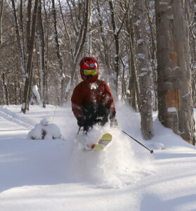 An image of Dylan skiing in powder snow at Bolton Valley Resort in Vermont after nearly two feet of snow from Winter Storm Kade