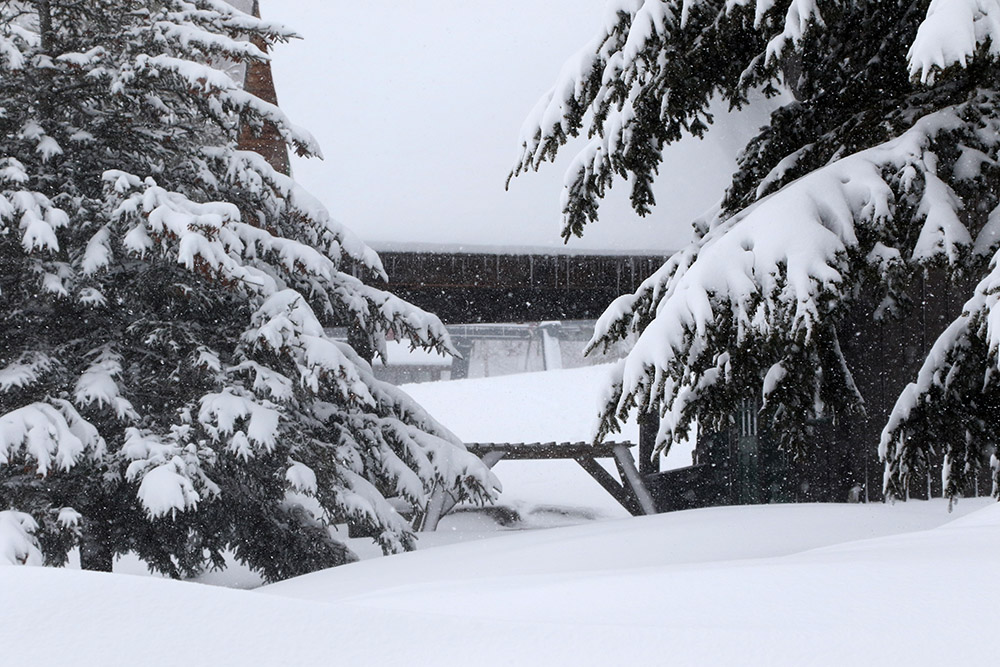 A snowy view of the Timberline Base Lodge during Winter Storm Odell at Bolton Valley Ski Resort in Vermont