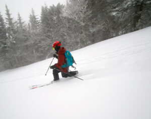 An image of Dylan Telemark skiing in powder from Winter Storm Quincy at Bolton Valley Resort in Vermont