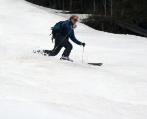 An image of Erica Telemark skiing on the Showtime trail during a spring ski tour at Bolton Valley Resort in Vermont