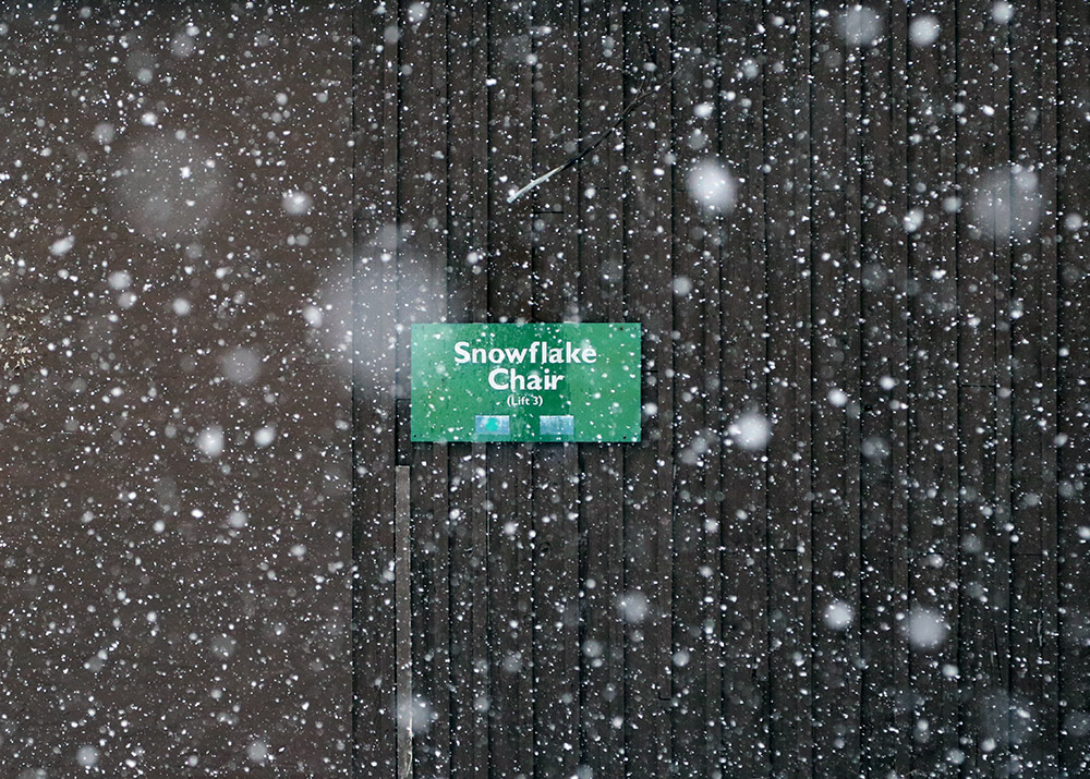 An image of snow falling at the base of the Snowflake lift during a late-April snowstorm at Bolton Valley Ski Resort in Vermont.