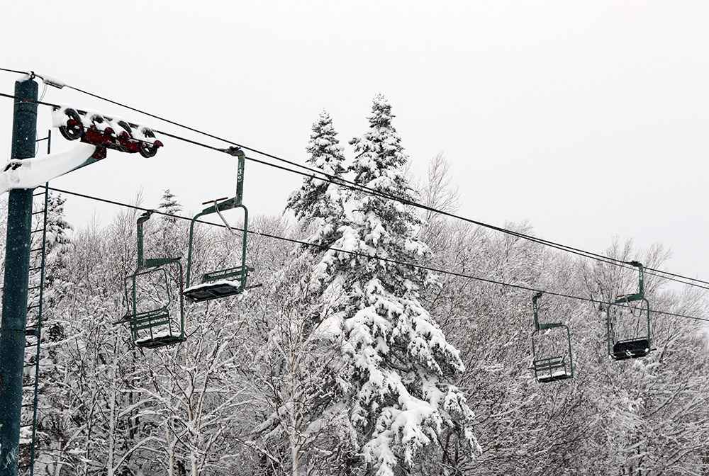 An image of the Wilderness double chairlift taken during a ski tour during a late-April snowstorm at Bolton Valley Ski Resort in Vermont