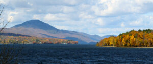 An image of foliage in the Newport, VT area along Lake Memphremagog with the mountain Owl's Head visible off in Canada.