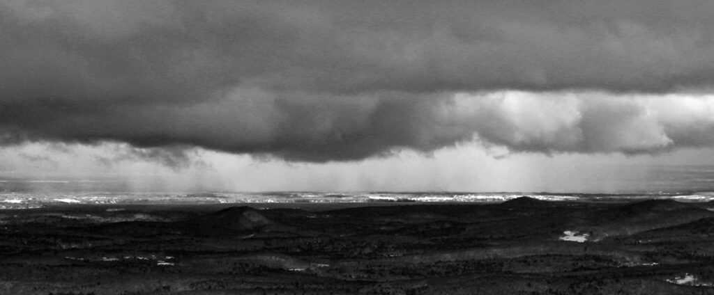 An image of a snow shower down in the Champlain Valley taken from the top of Bolton Valley Resort in Vermont