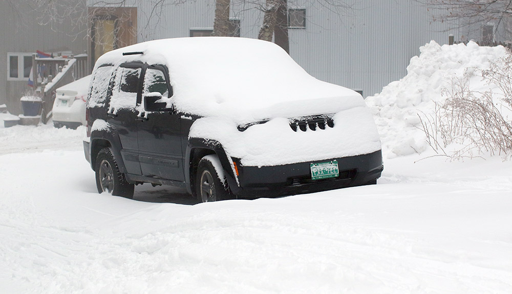 An image of a vehicle covered in snow from Winter Storm John in the Village area at Bolton Valley Ski Resort in Vermont