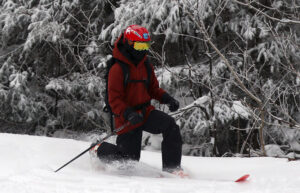 An image of Dylan Telemark skiing in powder from Winter Storm John while ski touring in the Wilderness area at Bolton Valley Resort in Vermont