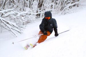 An image of Ty skiing in fresh powder from Winter Storm Malcolm at Bolton Valley Resort in Vermont