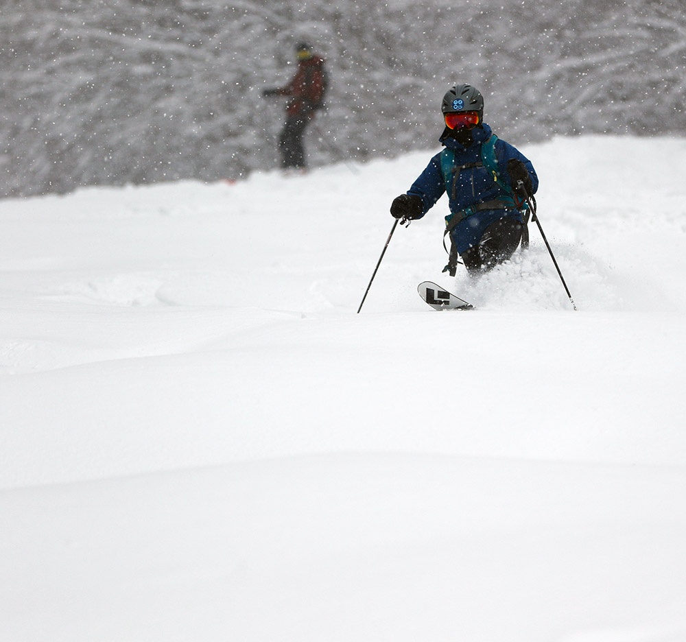 An image of Erica skiing on the Twice as Nice Trail during Winter Storm Malcolm at the Timberline area of Bolton Valley Ski Resort in Vermont