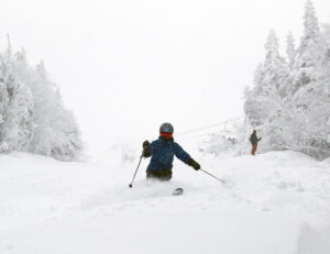 An image of Erica skiing the Hard Luck trail in snow from Winter Storm Malcolm at Bolton Valley Ski Resort in Vermont