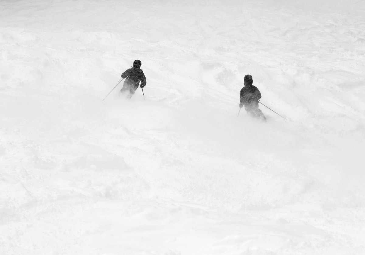 An image of Ty and Dylan skiing powder snow left by upslope precipitation during a January storm at Bolton Valley Ski Resort in Vermont