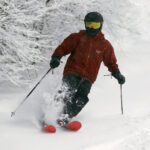 An image of Dylan skiing powder during a January snowstorm at Bolton Valley Resort in Vermont