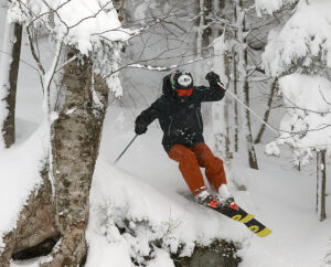 An image of Ty skiing trees in the Timberline area of Bolton Valley Resort in Vermont during a January snowstorm