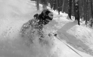 An image of Ty skiing through powder after Winter Storm Roland in the Doug's Solitude area of Bolton Valley Ski Resort in Vermont