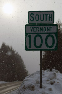 An image of a road sign for Route 100 in Vermont during a bout of February snow