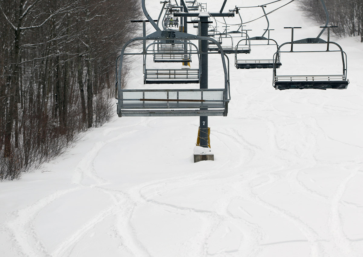 An image showing ski tracks in powder snow below the Timberline Chairlift at Bolton Valley Ski Resort in Vermont