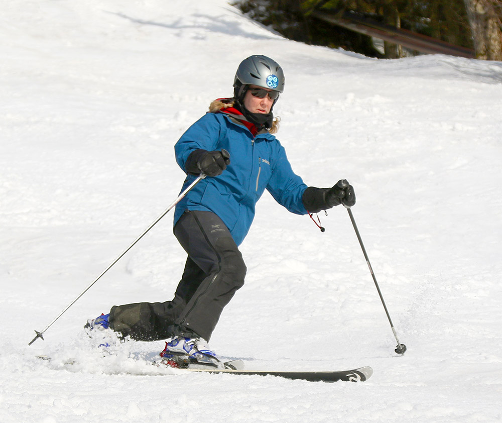 An image of Erica Telemark skiing in spring snow in March at Bolton Valley Ski Resort in Vermont
