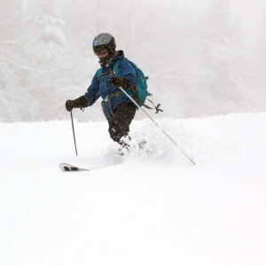An image of Erica Telemark skiing in snow from an April snowstorm at Pico Mountain Ski Resort in Vermont