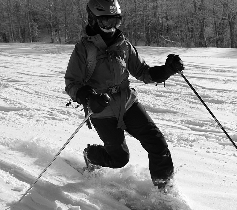 An image of Erica Telemark skiing in some powder on the Wilderness Lift line during a ski tour at Bolton Valley Resort in Vermont