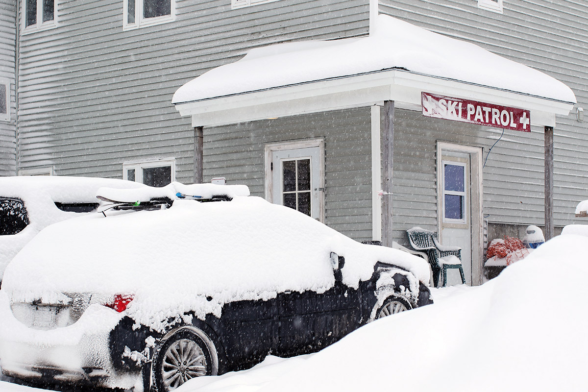 An image of the Ski Patrol Headquarters area at Bolton Valley Ski Resort in Vermont with fresh snow from Winter Storm Izzy