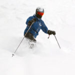 An image of Erica Telemark skiing in powder at Bolton Valley Resort in Vermont during Winter Storm Izzy