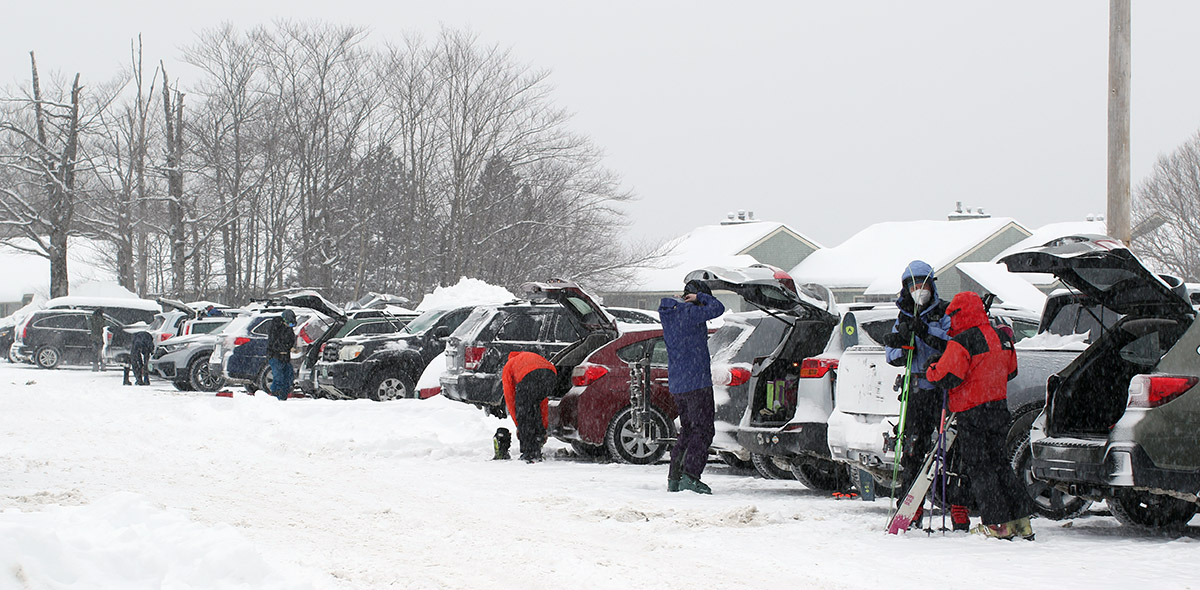 An image of skiers in the parking lot preparing for a day of skiing the fresh snow of Winter Storm Landon at Bolton Valley Resort in Vermont