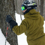 An image of Jay standing near a tree in the glades at Bolton Valley Ski Resort in Vermont