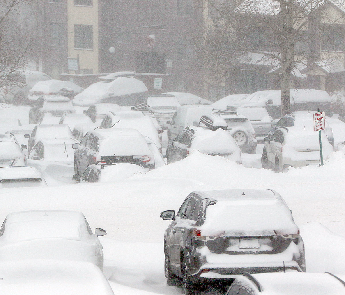 An image of the parking lots containing cars covered with snow during Winter Storm Quinlan at Bolton Valley Ski Resort in Vermont