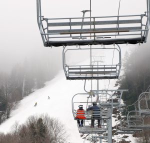 An image of the Spillway trail rising into the clouds while riding the Vista Quad Chairlift at Bolton Valley Ski Resort in Vermont