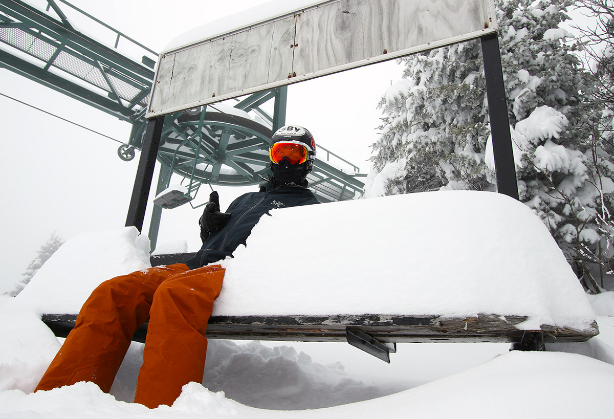 An image of Ty sitting on a bench with snow at the Wilderness Summit at Bolton Valley Ski Resort in Vermont