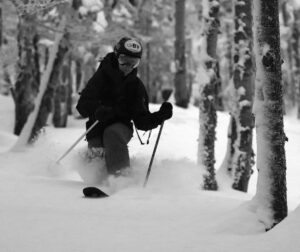 An image of Ty Telemark skiing powder from Winter Storm Diaz in some of the glades on the Backcountry Network at Bolton Valley Ski Resort in Vermont
