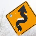 A road sign with a bit of fresh snow stuck to it along the Bolton Valley Access Road below Bolton Valley Ski Resort in Vermont