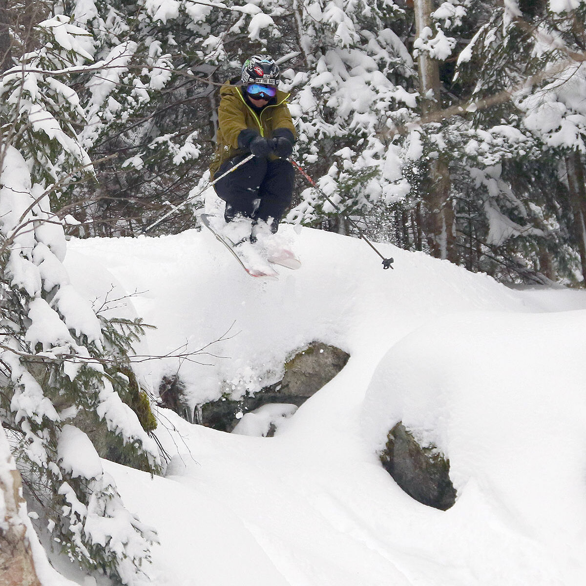 An image of Jay jumping in the Wood's Hole area of Timberline after plentiful snow from Winter Storm Kassandra at Bolton Valley Ski Resort in Vermont