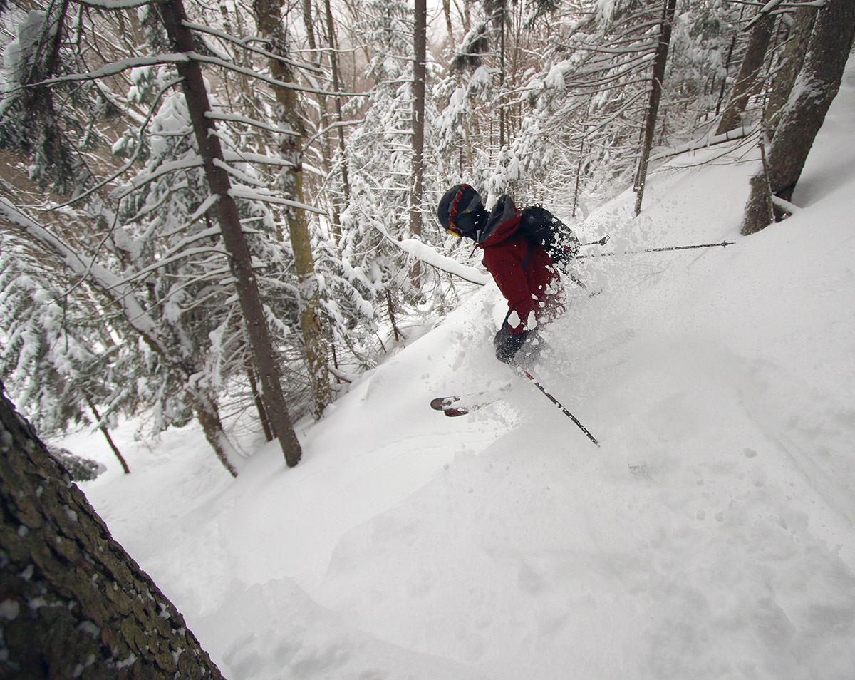 An image of Dylan catching some air while dropping into the KP Cliffs area of Bolton Valley Ski Resort in Vermont during Winter Storm Quest