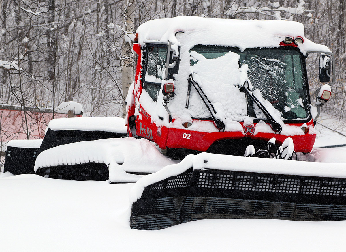An image of a snowcat covered in snow from the first part of Winter Storm Sage near the Timberline Base Lodge at Bolton Valley Ski Resort in Vermont
