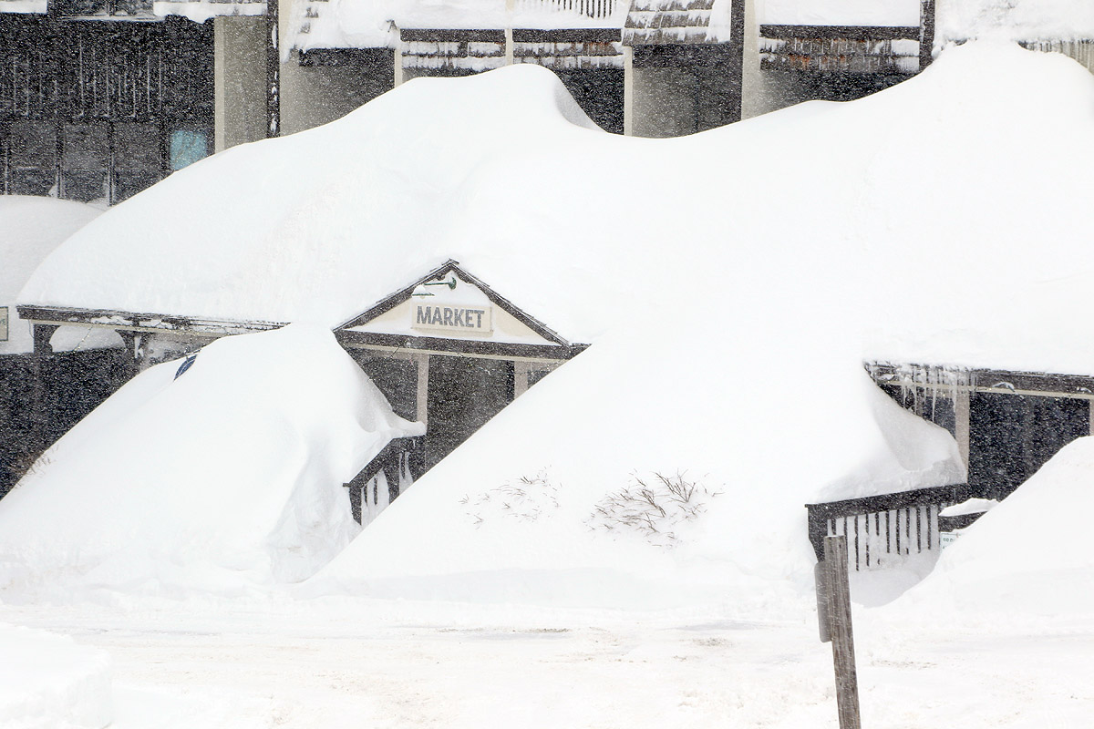 An image of deep snow from recent winter storms hiding the Mountain Market in the Village area at Bolton Valley Ski Resort in Vermont