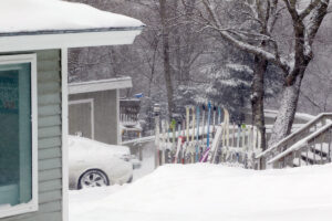 An image of skis on a ski rack at a house along the Wilderness Double Chairlift in the Village area of Bolton Valley Ski Resort in Vermont