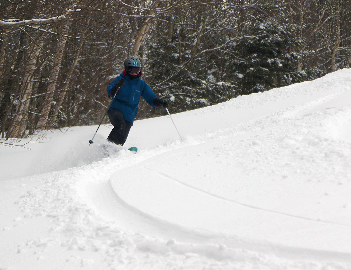 An image of Erica Telemark skiing in powder in the Valley Road area after a late March snowstorm at Bolton Valley Resort in Vermont
