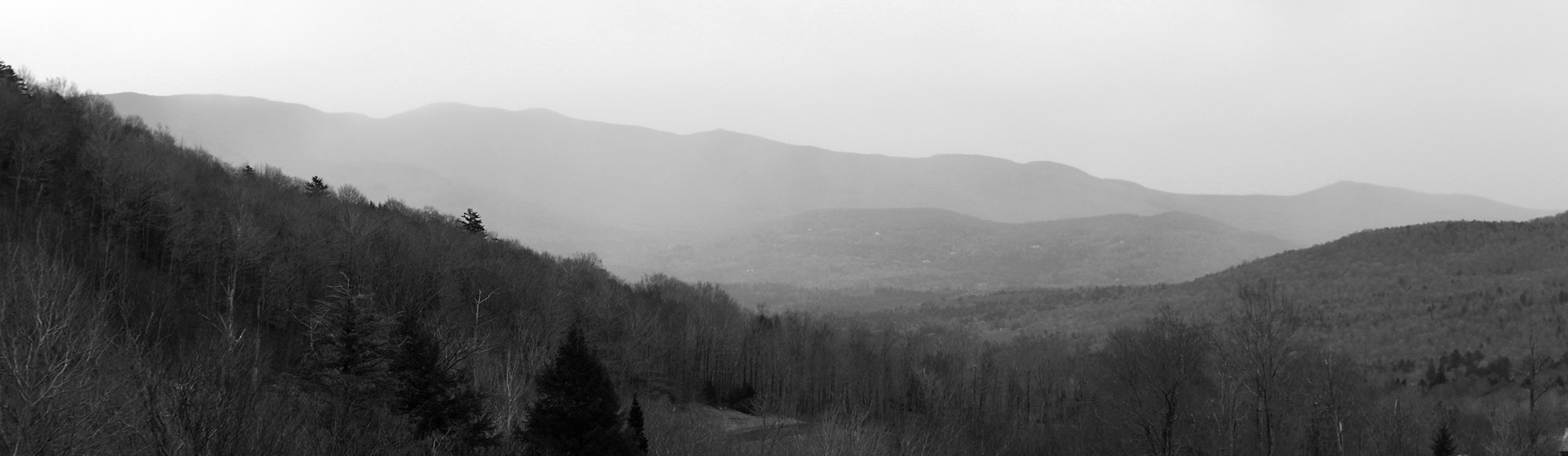 An image of peaks of the Green Mountains to the south of Stowe Mountain Resort in Vermont disappearing as a storm moves into the area.