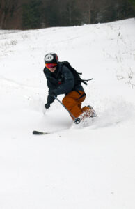 An image of Ty Telemark skiing in some fresh snow from a pre-Thanksgiving snowstorm up at Bolton Valley Resort in Vermont