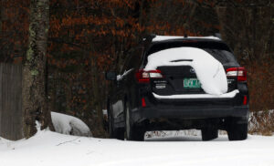 An image of snow sliding off a car as temperatures warm in the Village area at Bolton Valley Ski Resort in Vermont