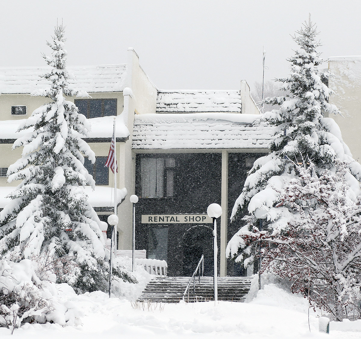 An image of heavy snowfall and snow accumulations at the main base lodge in the Village during an early December snowstorm at Bolton Valley Ski Resort in Vermont