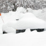 An image of a snowmobile buried in snow from recent early December storms at Bolton Valley Ski Resort in Vermont